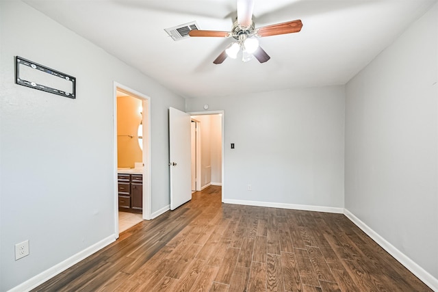 unfurnished bedroom with dark hardwood / wood-style flooring, ensuite bath, and ceiling fan