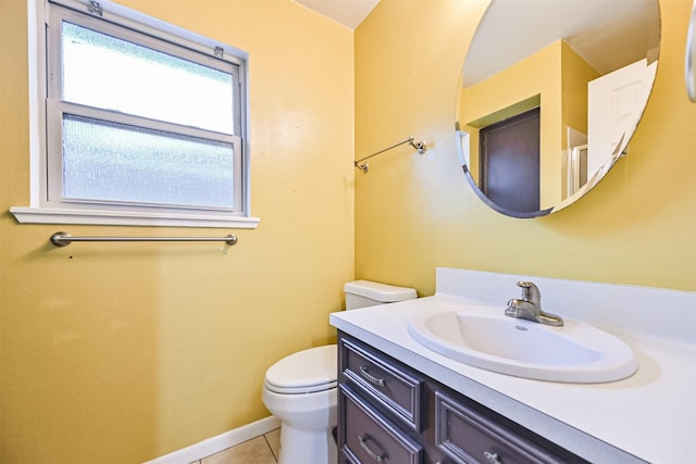 bathroom featuring vanity, tile patterned floors, and toilet