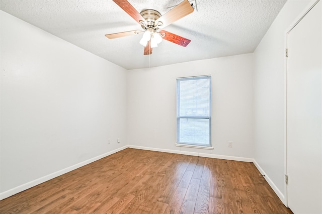 spare room with ceiling fan, hardwood / wood-style flooring, and a textured ceiling