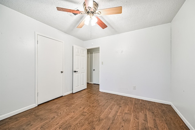 unfurnished bedroom featuring hardwood / wood-style floors, a closet, a textured ceiling, and ceiling fan