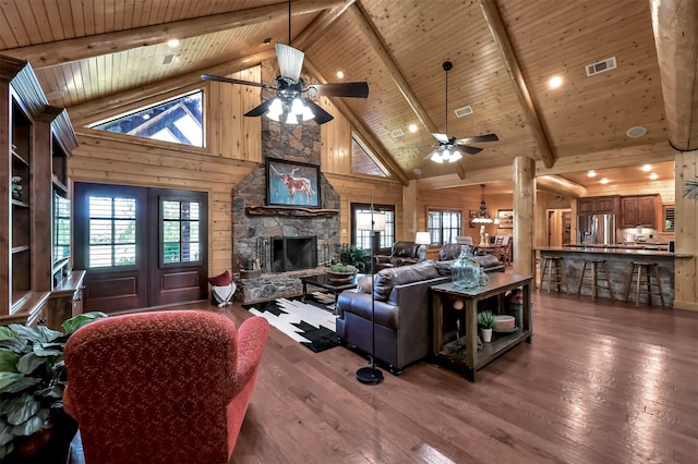 living room with wood ceiling, wooden walls, a wealth of natural light, and hardwood / wood-style flooring