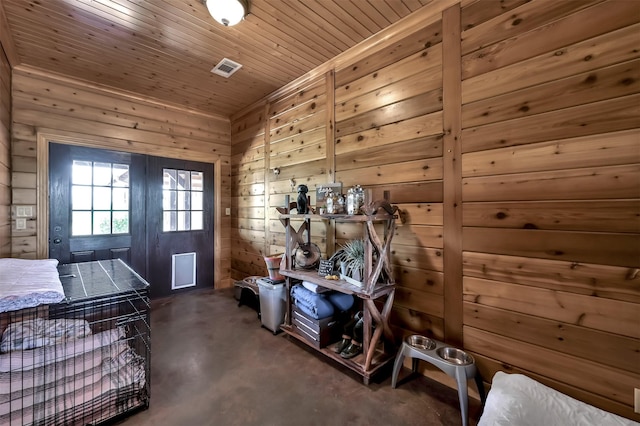 entryway with wood ceiling and wood walls