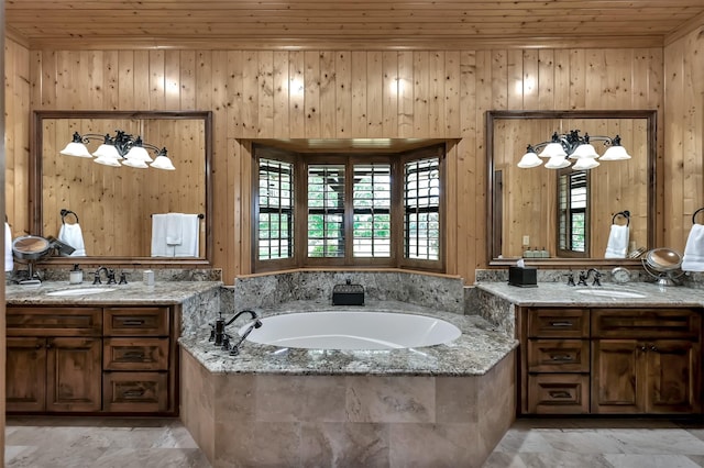 bathroom with a relaxing tiled tub, wood ceiling, and vanity