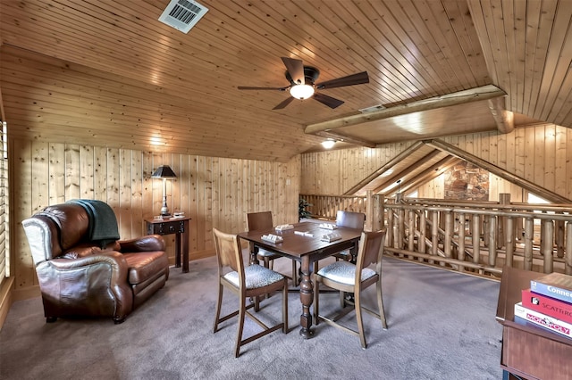 carpeted dining area with ceiling fan, wooden walls, vaulted ceiling, and wooden ceiling