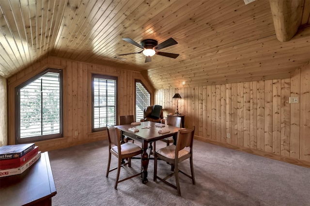 carpeted dining area with wood walls, lofted ceiling, and wooden ceiling