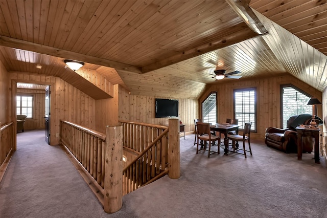 additional living space featuring wood ceiling, vaulted ceiling with beams, carpet, and wood walls