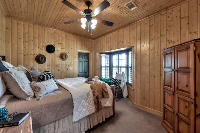 carpeted bedroom with ceiling fan, wooden ceiling, and wooden walls