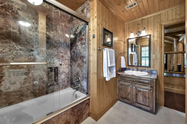 bathroom featuring vanity, wooden walls, wooden ceiling, and shower / bath combination with glass door