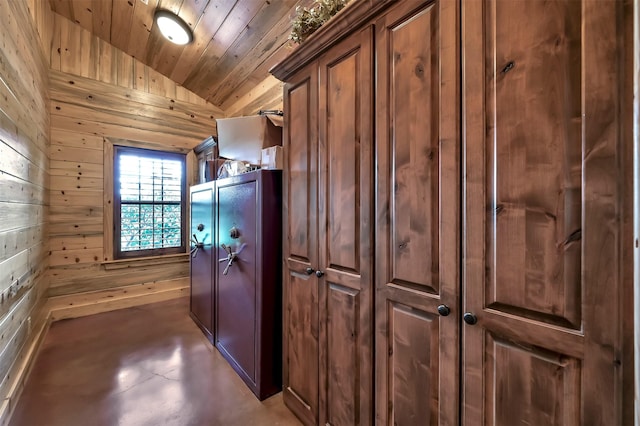 interior space with wood ceiling, lofted ceiling, and wooden walls