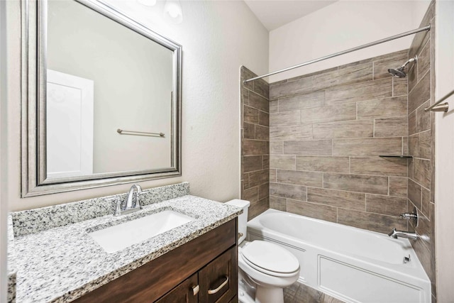 full bathroom with tiled shower / bath combo, vanity, and toilet