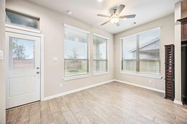 entryway with ceiling fan and light hardwood / wood-style floors