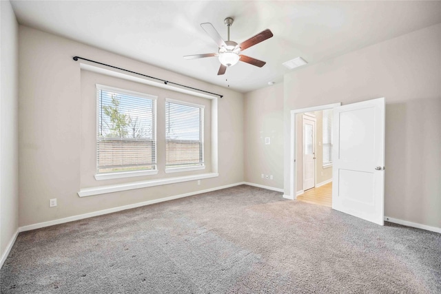 unfurnished room with ceiling fan and light carpet