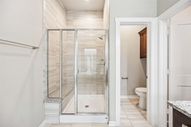 bathroom with a shower with door, vanity, and toilet