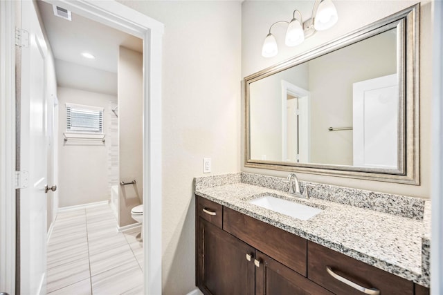 bathroom with vanity and toilet