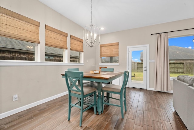 dining area featuring an inviting chandelier and hardwood / wood-style floors