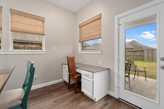 home office with dark wood-type flooring