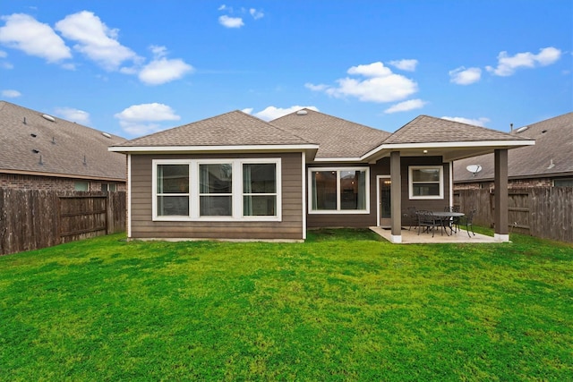 back of property featuring a yard and a patio