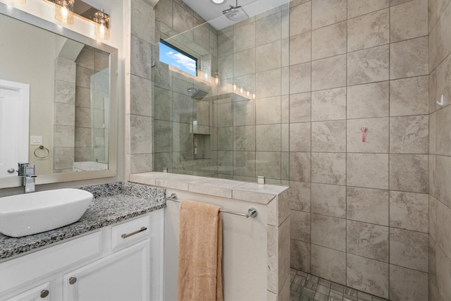 bathroom with vanity and tiled shower