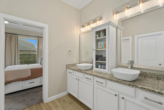 bathroom featuring hardwood / wood-style flooring and vanity