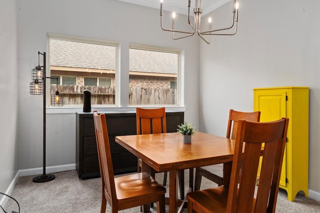 dining space with light carpet and an inviting chandelier