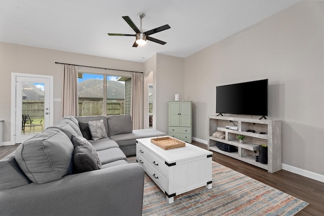 living room featuring dark hardwood / wood-style floors and ceiling fan