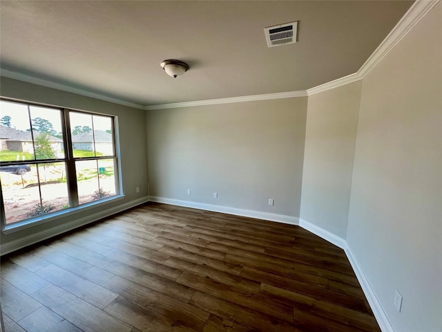 spare room with ornamental molding and dark wood-type flooring