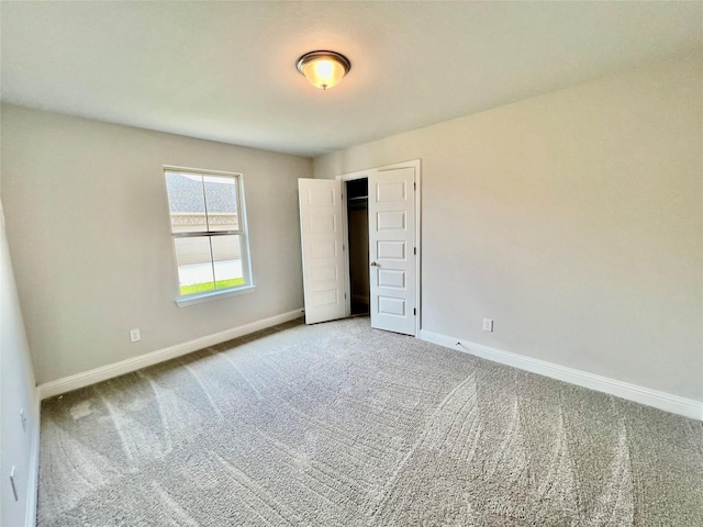 unfurnished bedroom with carpet and a closet