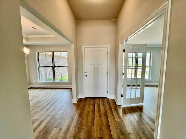 entrance foyer featuring hardwood / wood-style flooring and crown molding