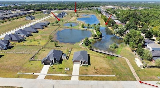 birds eye view of property with a water view