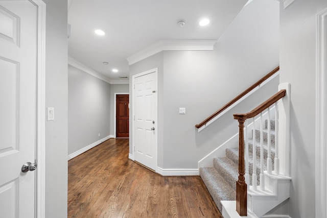 staircase featuring hardwood / wood-style flooring and ornamental molding