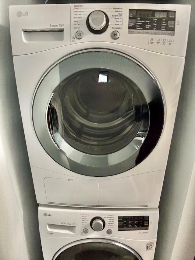 laundry room with a mail area and stacked washing maching and dryer