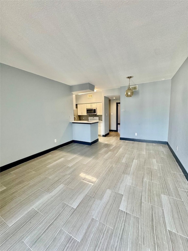 unfurnished living room with a textured ceiling