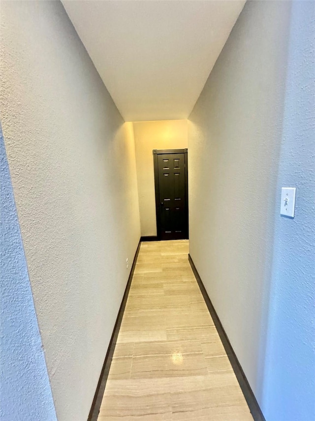 corridor with light hardwood / wood-style floors