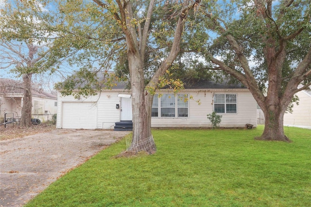 single story home featuring a garage and a front yard