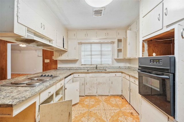 kitchen with sink, light tile patterned floors, gas cooktop, white cabinets, and oven