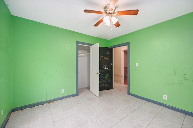 unfurnished bedroom with ceiling fan and a closet