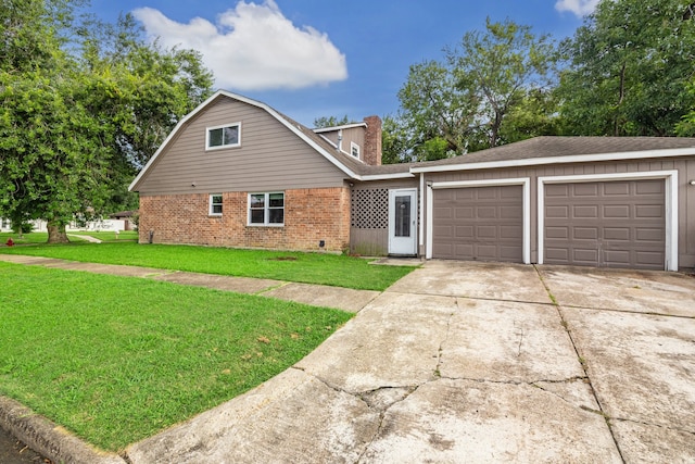 view of front of property with a garage and a front yard