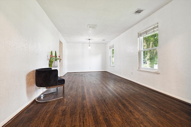 spare room with dark hardwood / wood-style floors