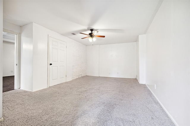 empty room featuring carpet flooring and ceiling fan