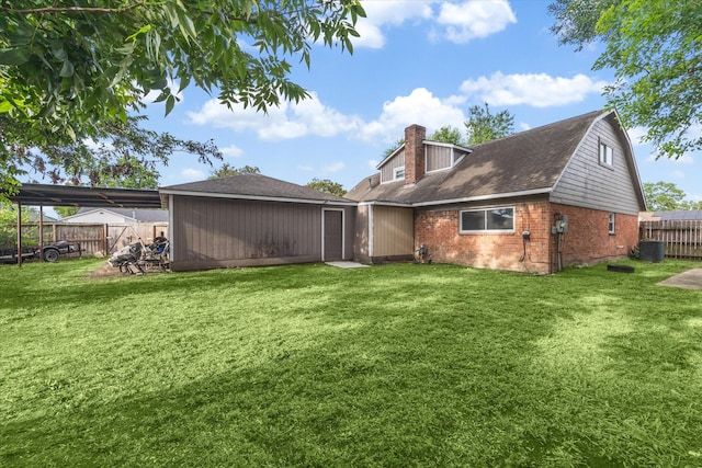 back of house featuring central AC unit and a yard