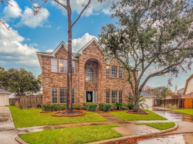 view of front of property with a garage and a front lawn