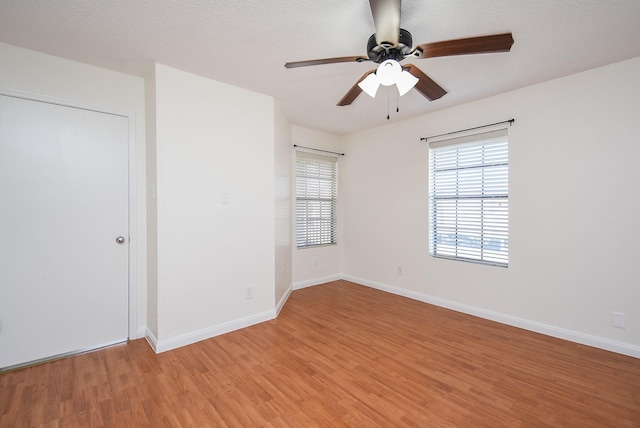 unfurnished bedroom featuring ceiling fan, light hardwood / wood-style floors, and a textured ceiling