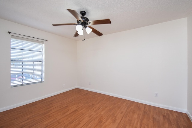 unfurnished room with wood-type flooring, ceiling fan, and a textured ceiling