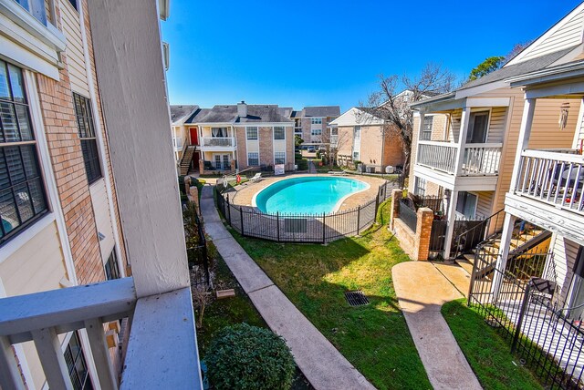 view of swimming pool with a patio and a lawn