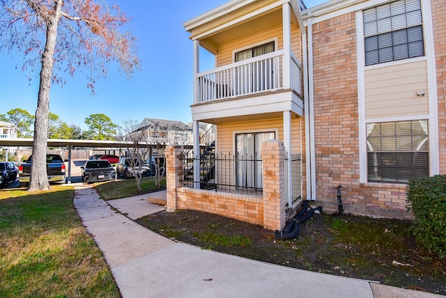 exterior space with a carport and a balcony