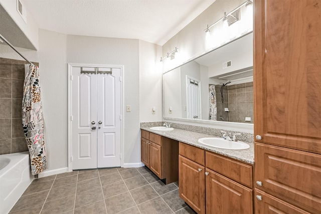 bathroom with shower / bath combination with curtain, tile patterned floors, vanity, and a textured ceiling