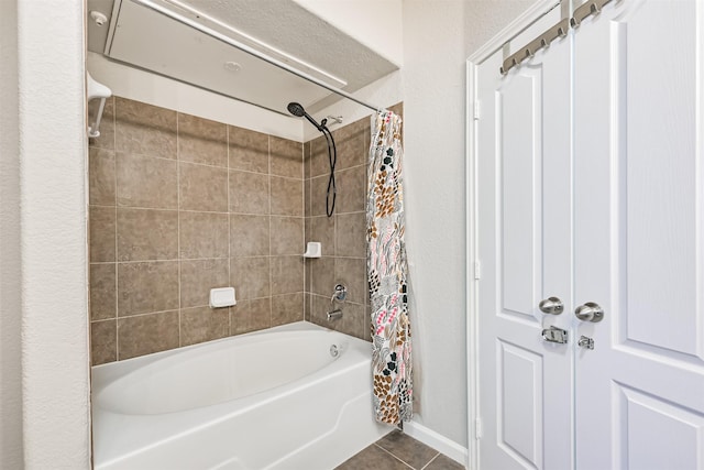 bathroom with shower / bathtub combination with curtain and tile patterned flooring