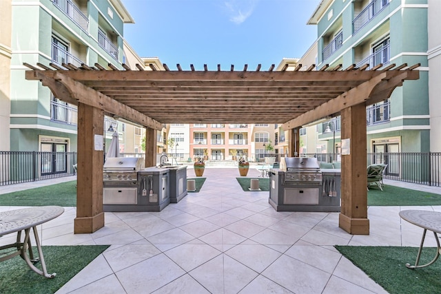 view of patio / terrace with grilling area, sink, a pergola, and area for grilling