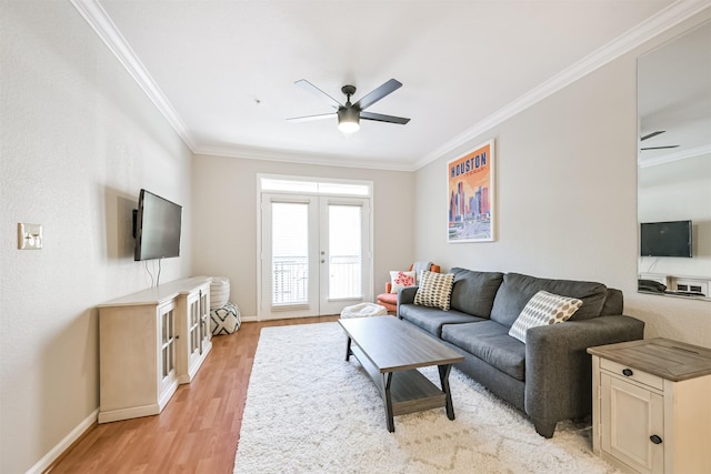 living room with french doors, ornamental molding, and light wood-type flooring