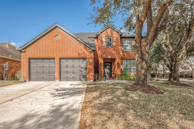 view of front property featuring a garage and a front yard